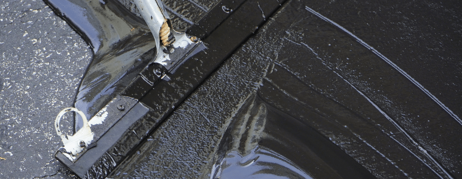 sealcoating being applied to asphalt